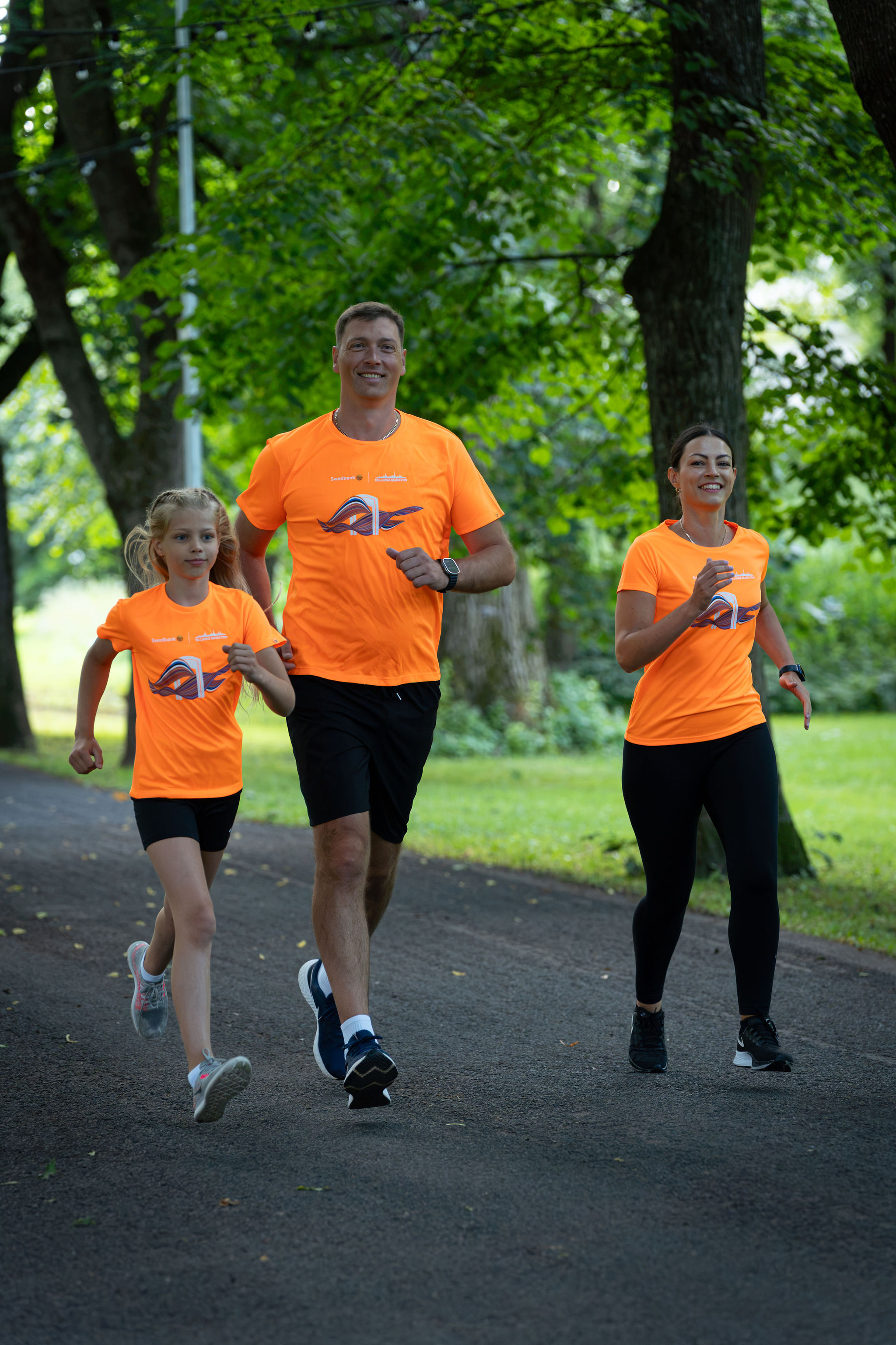 A family running in the official Tallinn Marathon 2026 T-shirts